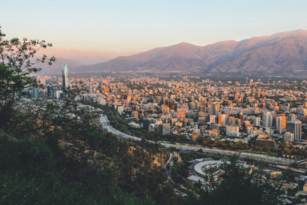 Breathtaking view of Santiago, Chile's skyline framed by mountains at sunset.